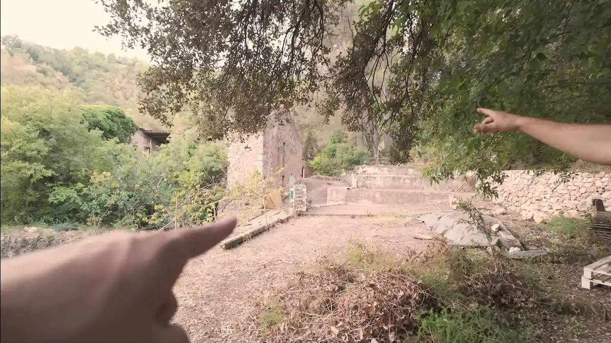 Ruinas de piedra del histórico molino papelero del siglo XVIII rodeadas de bosque en la finca autosuficiente.